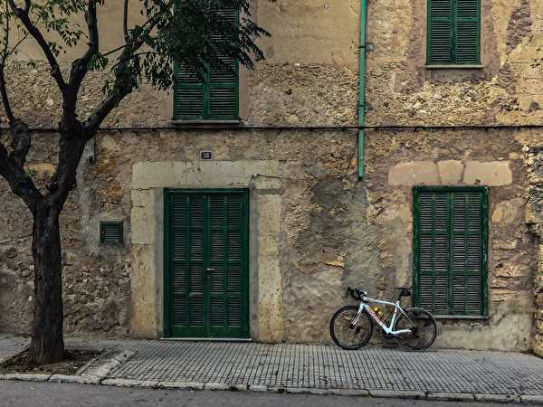 Bicycle in front of house wall