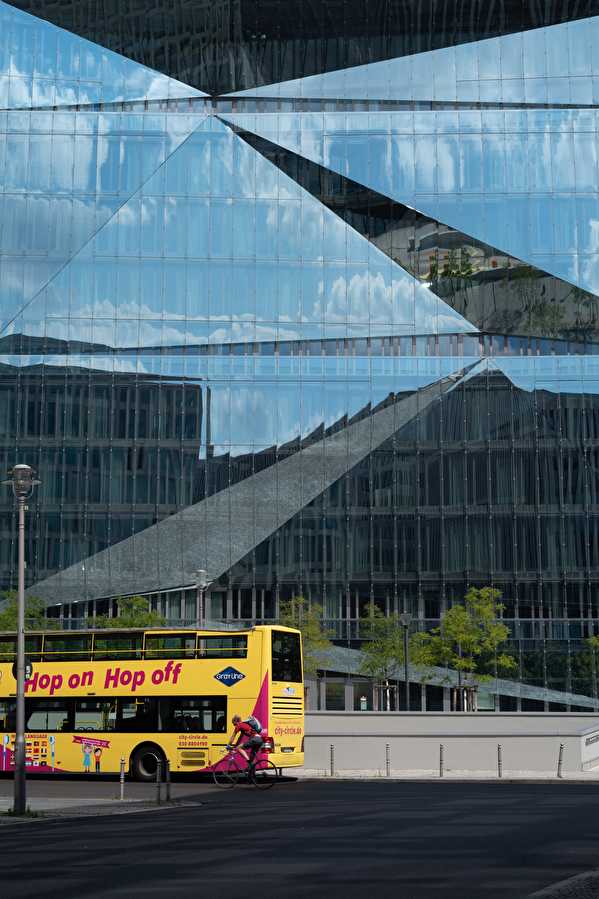 Bus in front of mirrored facade