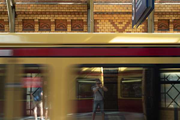 Photographer reflected in suburban train